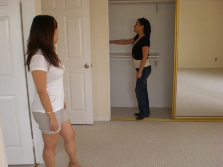 real estate agent showing closet space